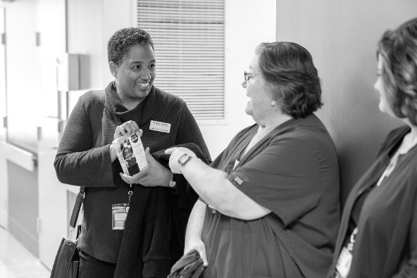 Photo credit PGCMLS (Left) Pamela Hamlin, the Library’s family literacy specialist, presents information about the Books From Birth program to Charlene Lopez (center), the coordinator of Lactation Services and Child Birth Education at MedStar Southern Maryland Hospital.