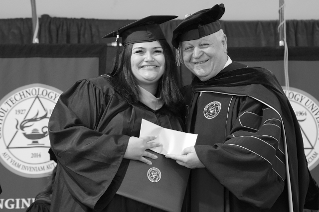 Courtesy Photo Dr. Kam Ghaffarian posing with graduate. Courtesy Photo Dr. Kam Ghaffarian posing with graduate.